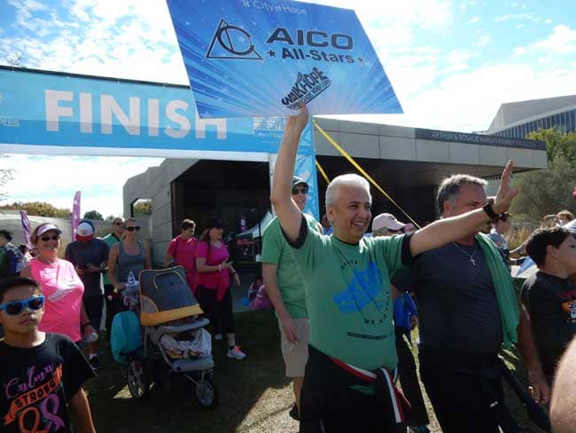 Michael Amini waves an AICO sign during November 5th’s Walk for Hope event.