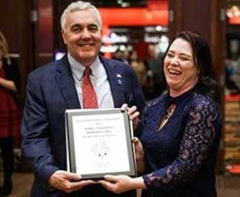 Pictured above:  Michael Pitman, Vice President of Ashley accepts the 2017 Double Diamond Sponsor plaque from Co-Host Myra Stone