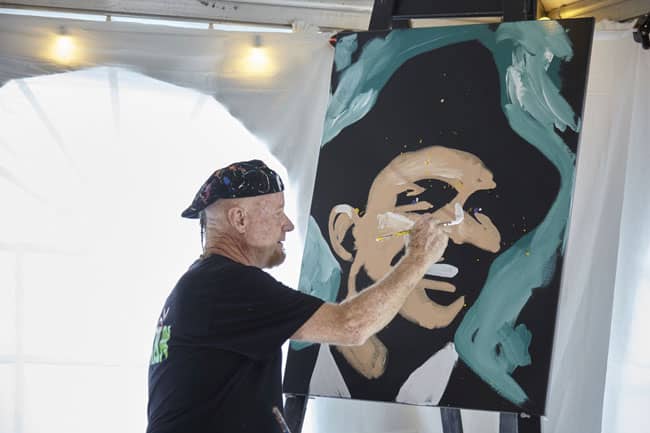Dale Henry paints a portrait of Frank Sinatra at the Esquire launch event.