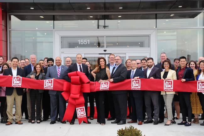 Official ribbon cutting ceremony with Art Van Furniture executives, team members and Nigel Barker, Cindy Crawford and Ron Boire, president and CEO of Art Van Furniture in the center.