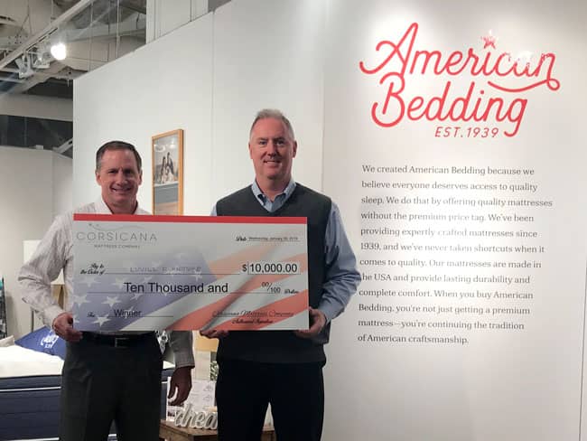 Michael Thompson, left, chief executive officer of Corsicana, and Eric Jent, vice president of sales for the company, showcase the $10,000 check for Pharr, Texas-based Luvill Furniture.
