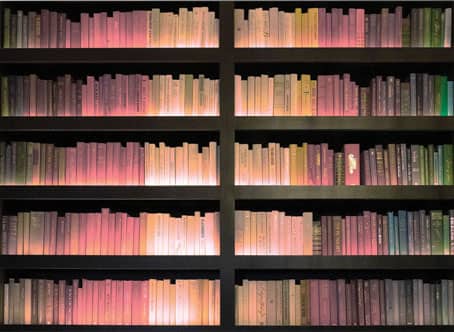 Glow Words: The glow of the books emits a feeling of tangibility as if the bookcases captured in the photo are actually on the wall and not a flat photograph.